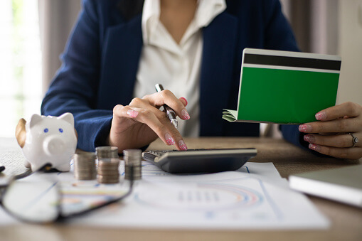 Image of woman using her check book